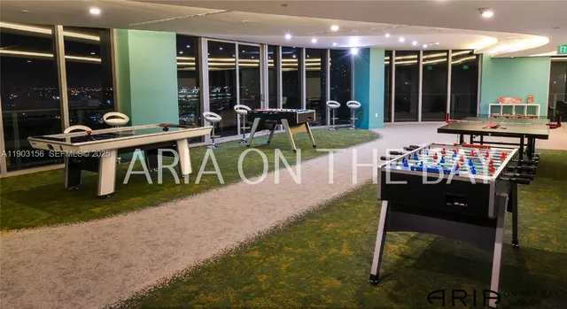 a view of a patio with table and chairs with plants and wooden fence