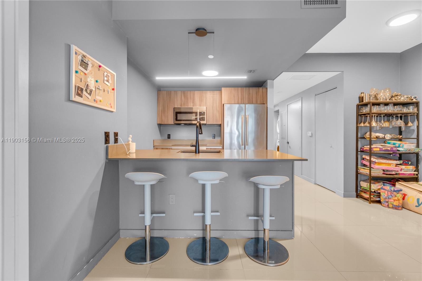 488 Northeast 18th Street, Unit 2104 Miami, FL 33132 - Photo 7 of 44 a kitchen with stainless steel appliances granite countertop a refrigerator and a stove top oven