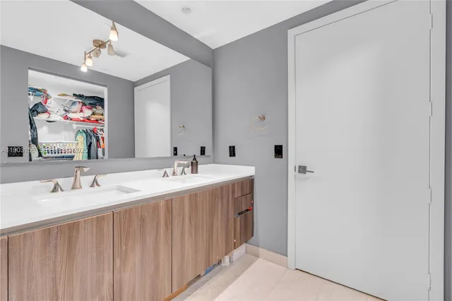 a bathroom with a double vanity sink and a mirror