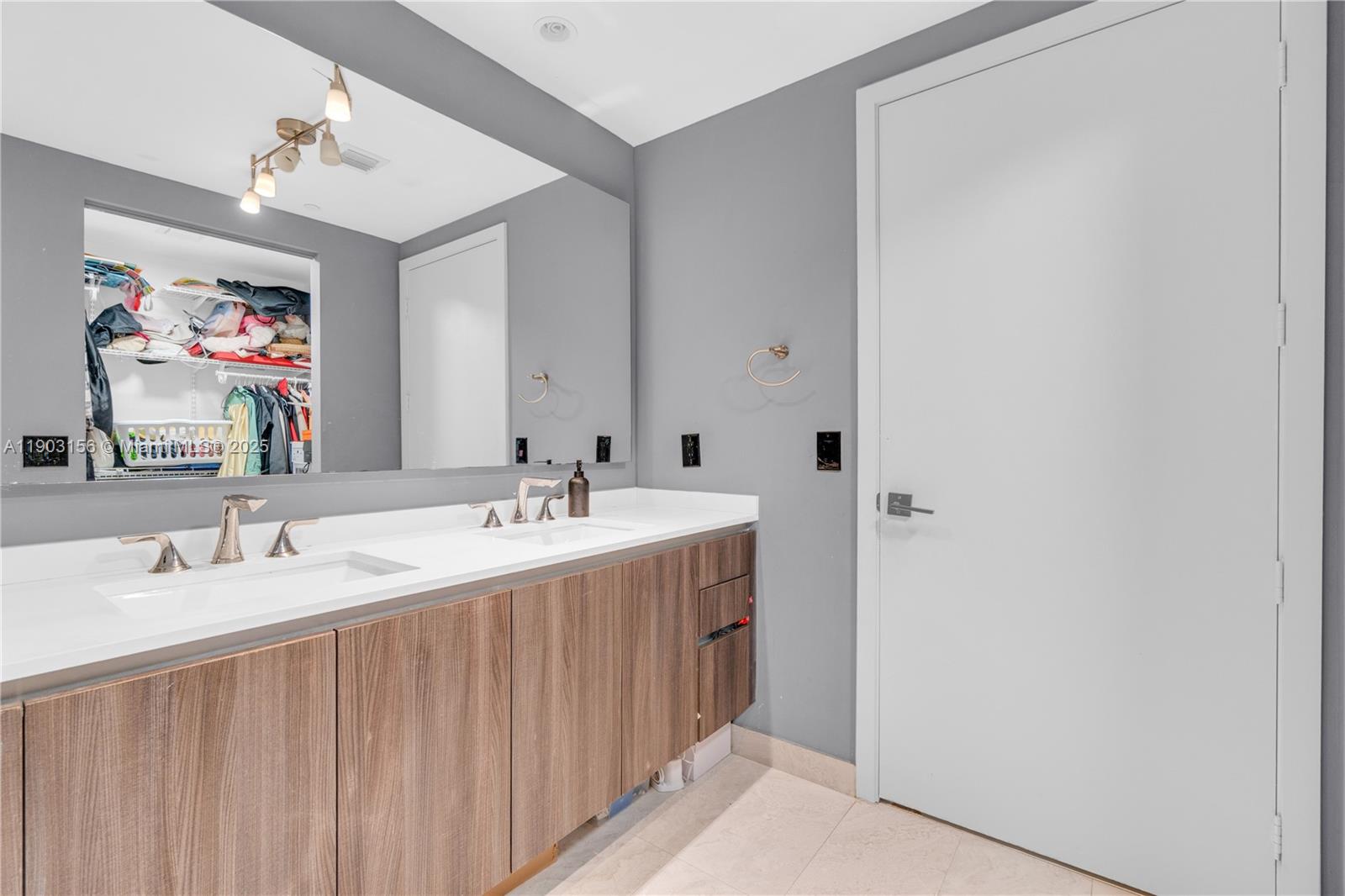 488 Northeast 18th Street, Unit 2104 Miami, FL 33132 - Photo 9 of 44 a bathroom with a double vanity sink and a mirror