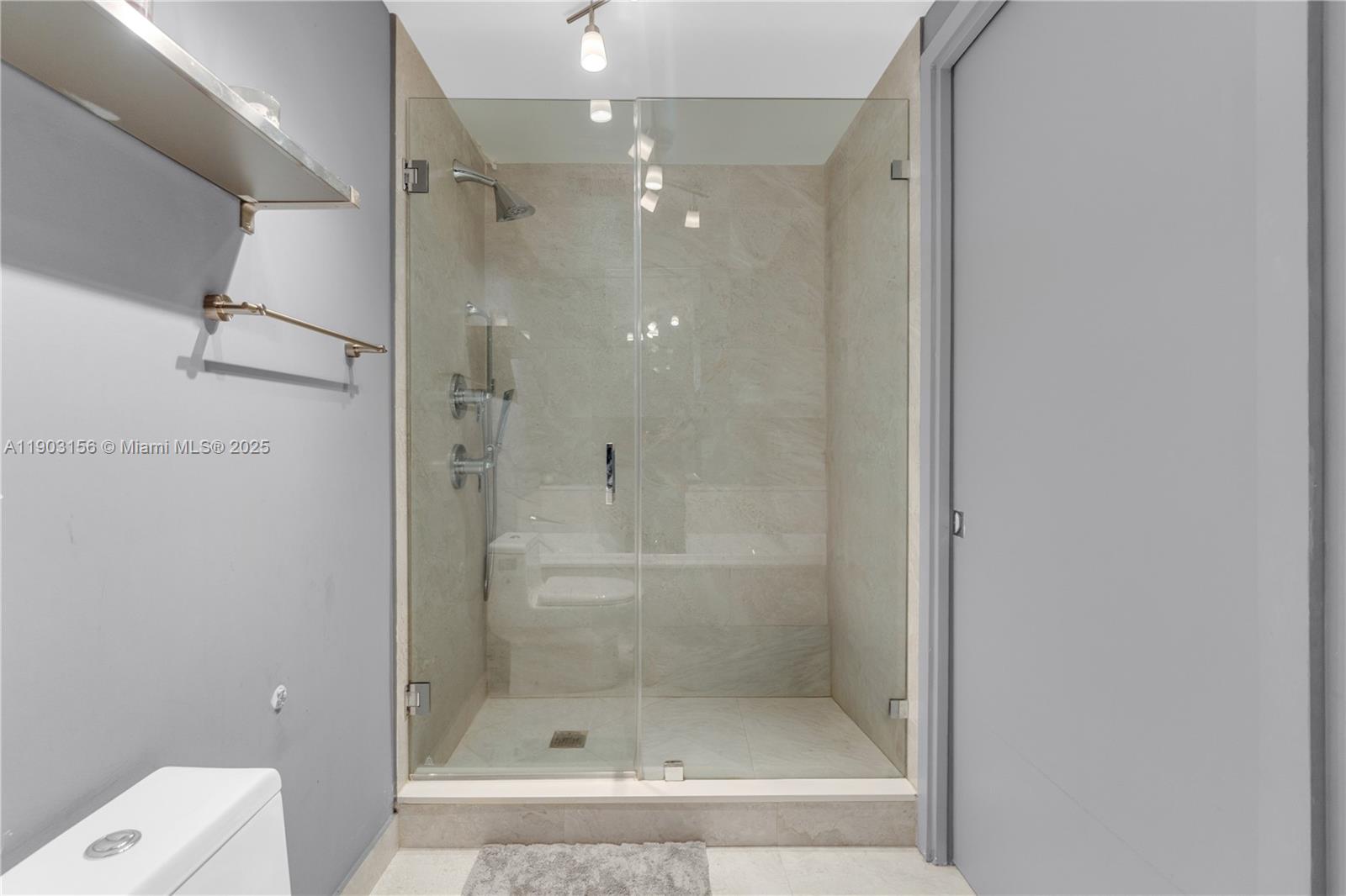 488 Northeast 18th Street, Unit 2104 Miami, FL 33132 - Photo 10 of 44 a bathroom with a shower and toilet