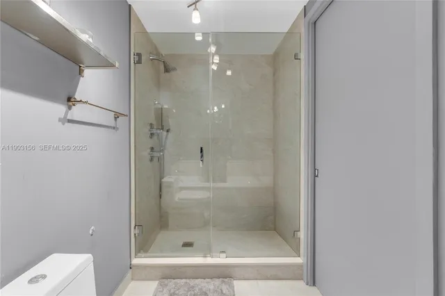 a bathroom with a shower and toilet