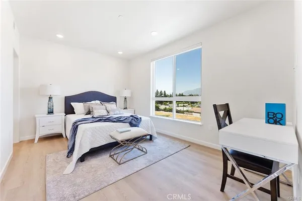 a bedroom with a bed a table and chair