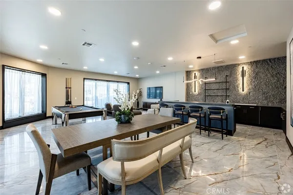 a kitchen with a dining table chairs and window