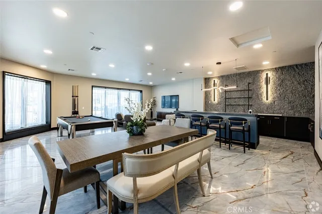 a kitchen with a dining table chairs and window