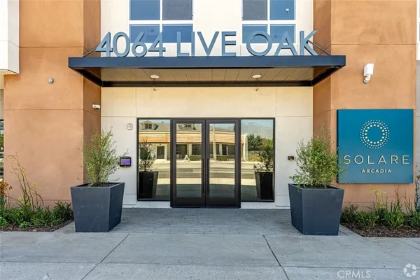 a front view of a house with potted plants