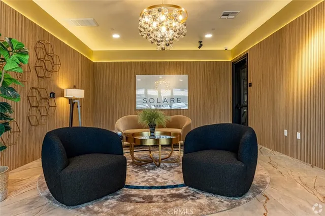 a living room with furniture and a chandelier