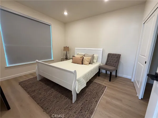 a bed room with a bed and a chair