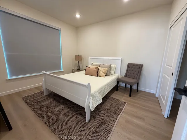 a bed room with a bed and a chair