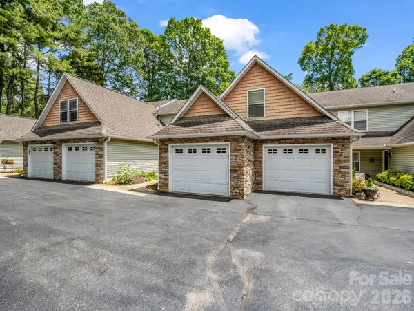a view of a house with a yard and garage