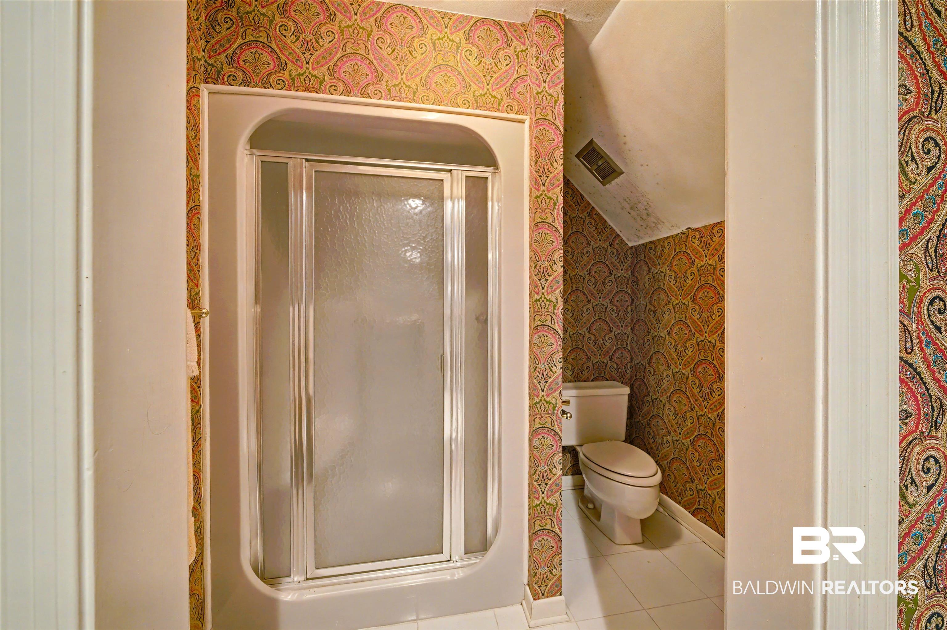 15810 County Road 73 Foley, AL 36535 - Photo 36 of 56 Bathroom with wallpapered walls, a shower stall, and tile patterned floors
