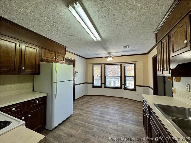 a kitchen with stainless steel appliances a refrigerator and a stove top oven