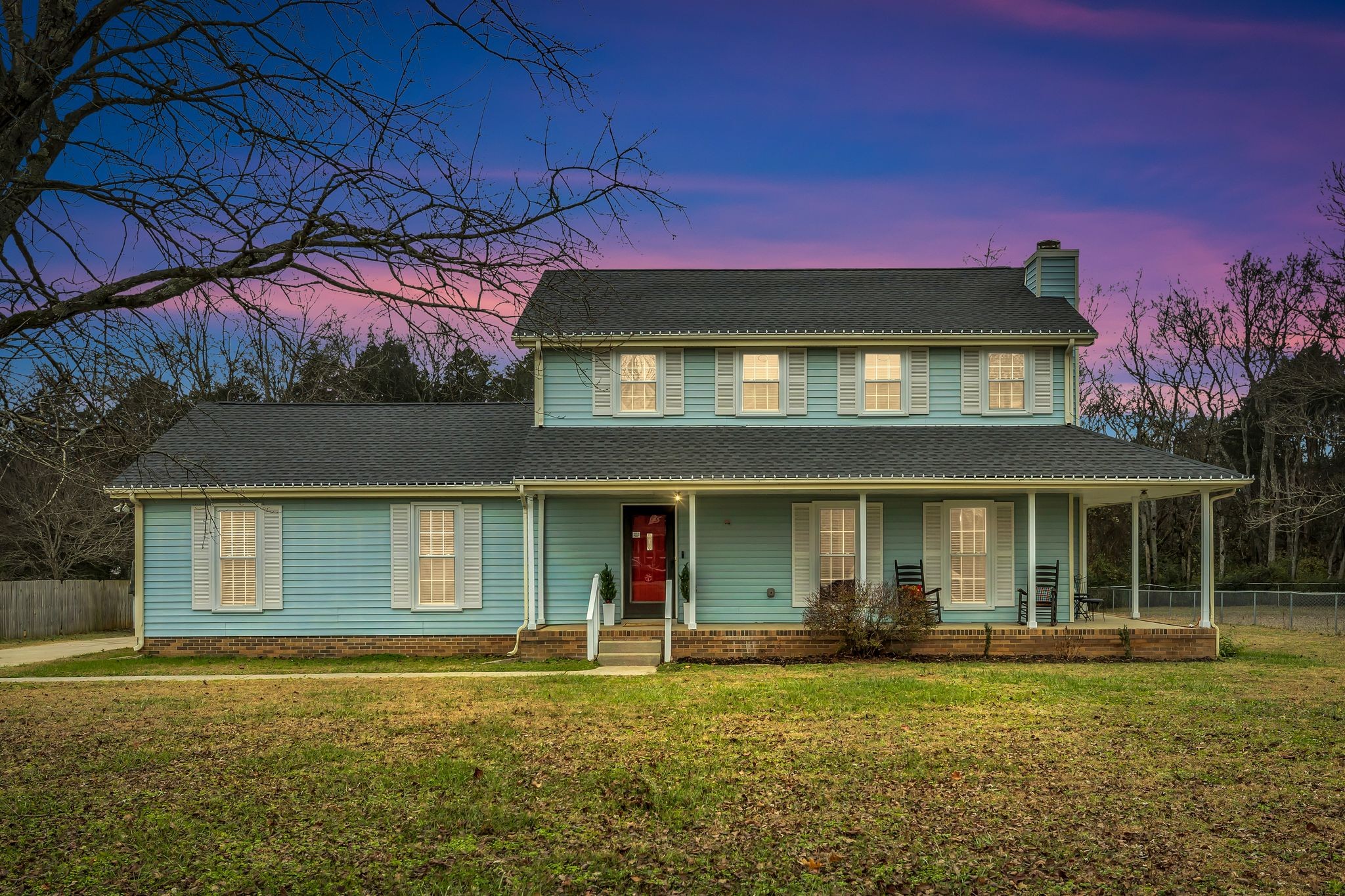 a front view of a house with a garden