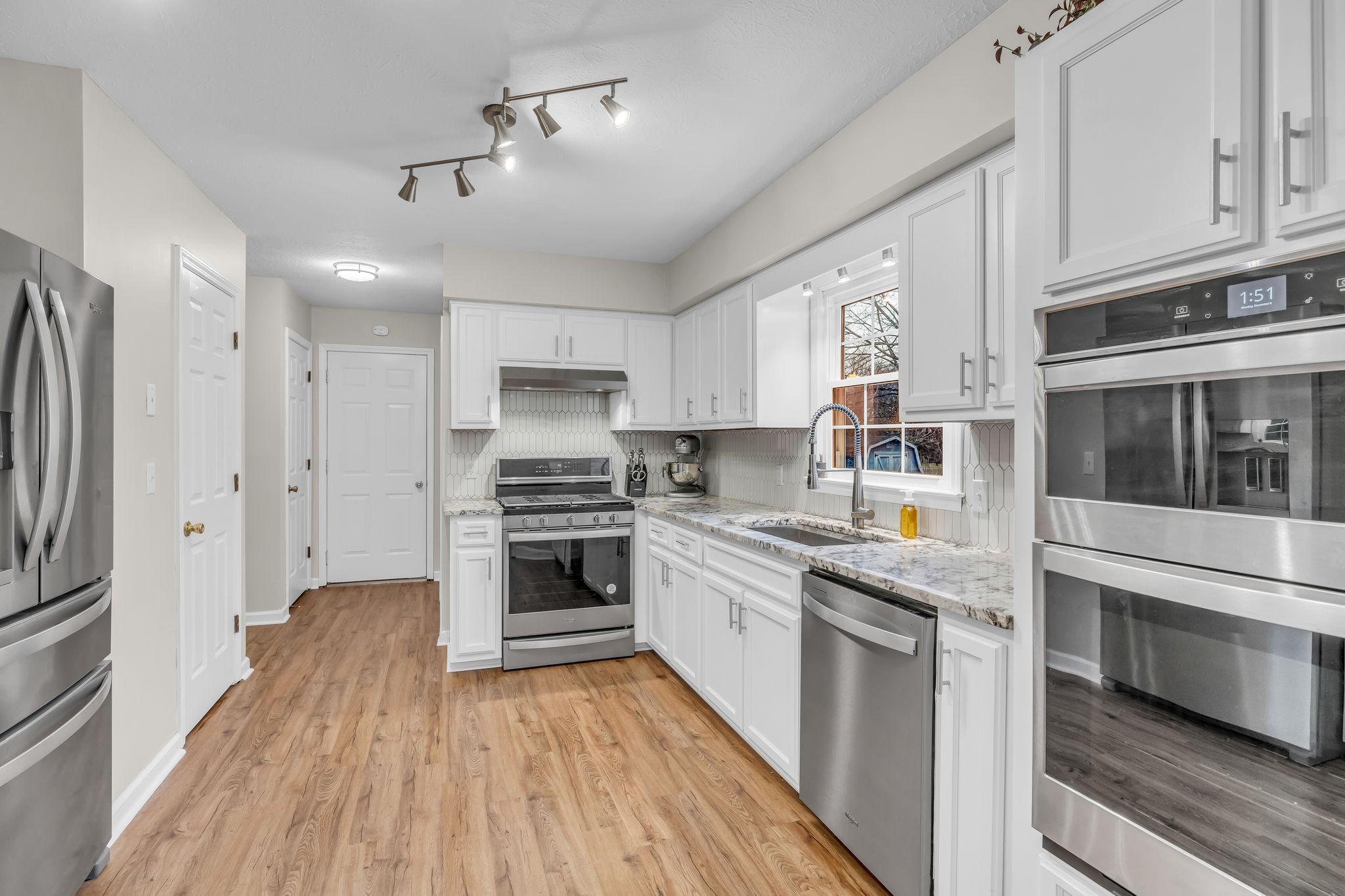 260 Pleasant Run Road Smyrna, TN 37167 - Photo 9 of 35 a kitchen with stainless steel appliances granite countertop a stove and a refrigerator