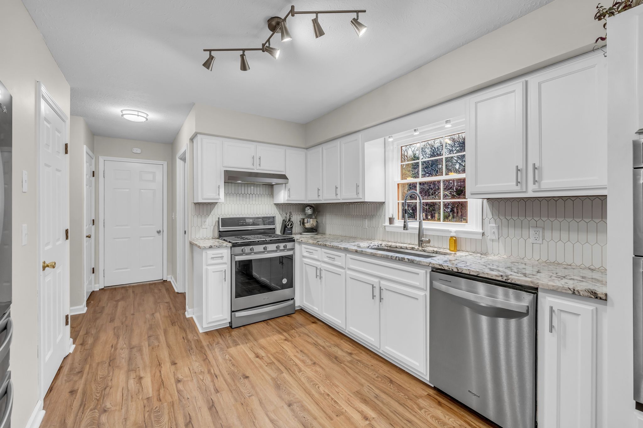 260 Pleasant Run Road Smyrna, TN 37167 - Photo 10 of 35 a kitchen with stainless steel appliances granite countertop a stove and white cabinets