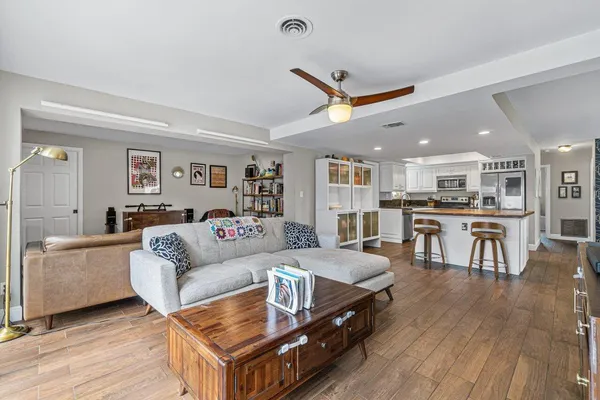 a living room with furniture and kitchen view