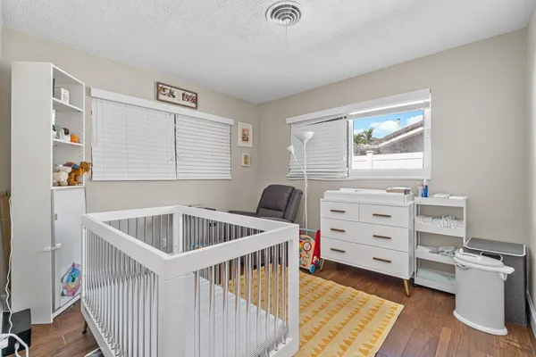 a kitchen that has a sink and a wooden floor