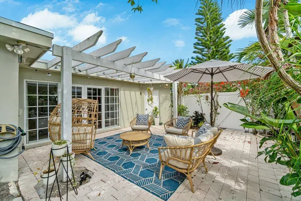 a backyard of a house with table and chairs