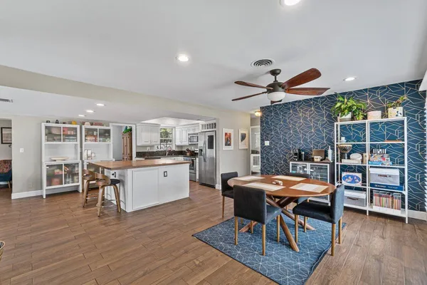 a dining room with furniture and wooden floor