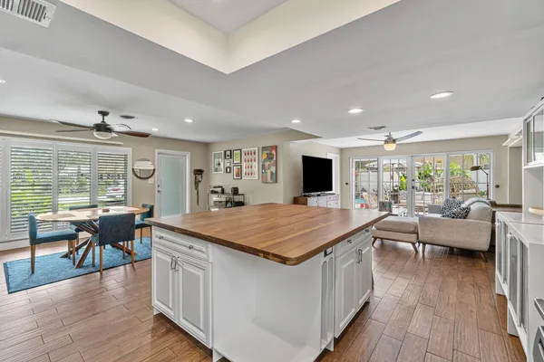 a room with furniture wooden floor and a large window