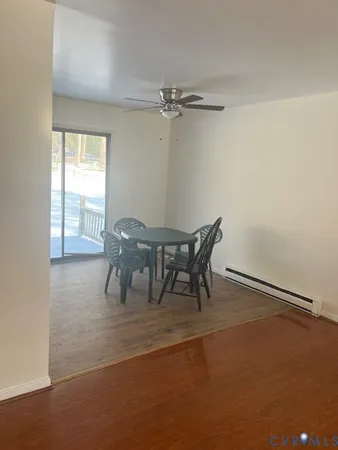 a dining room with furniture and a window