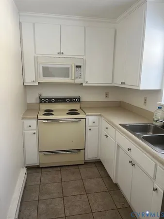 a kitchen with cabinets appliances and a sink