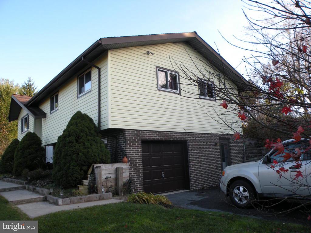 236 Zartman Mill Road Lititz, PA 17543 - Photo 7 of 22 a front view of a house with a garden and parking space