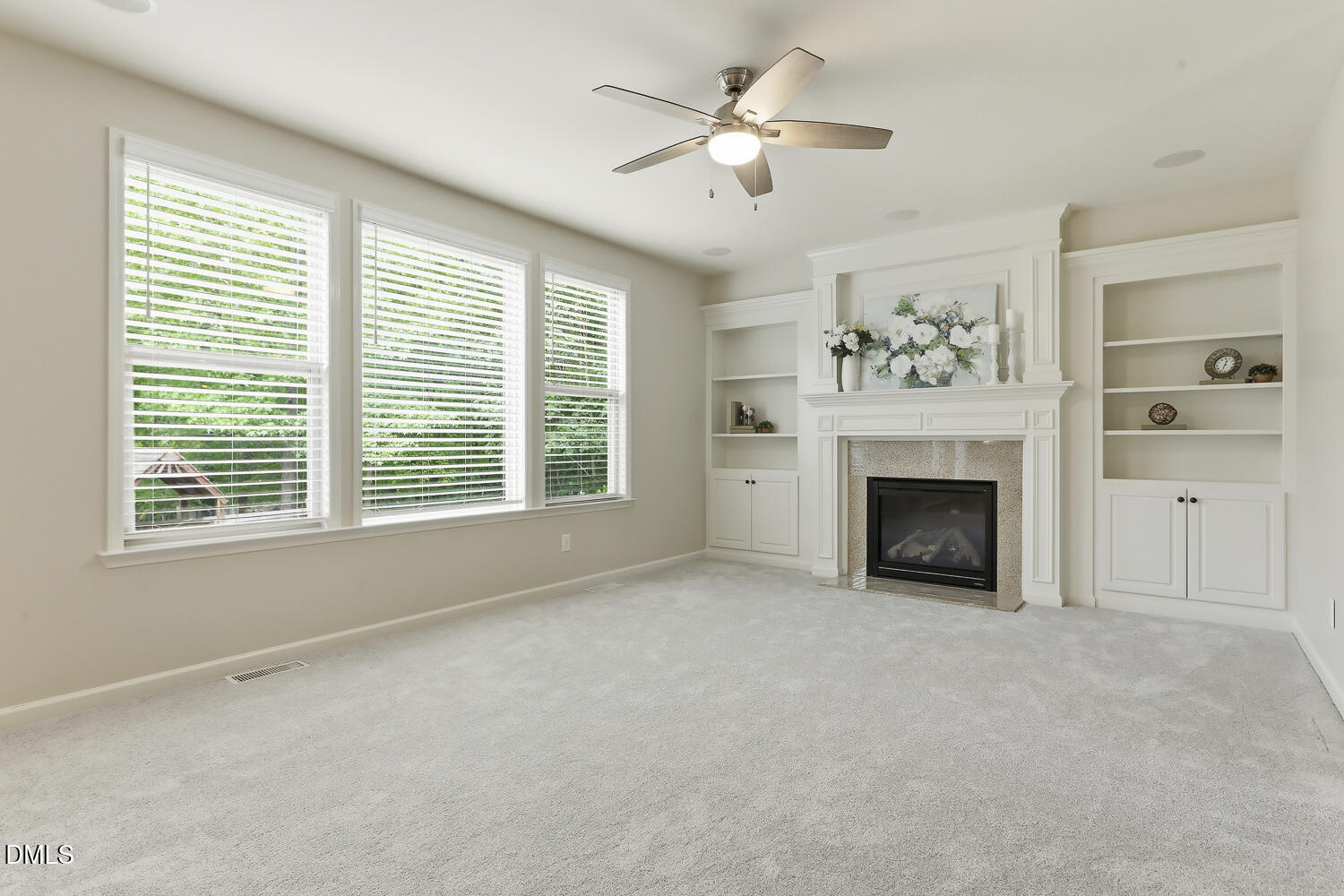 441 Virginia Water Drive Rolesville, NC 27571 - Photo 7 of 20 a view of empty room with a fireplace and fan