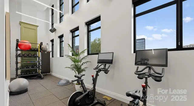 a room with gym equipment and large mirror