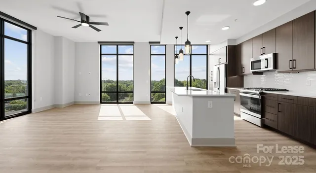a kitchen with a stove a sink and a refrigerator