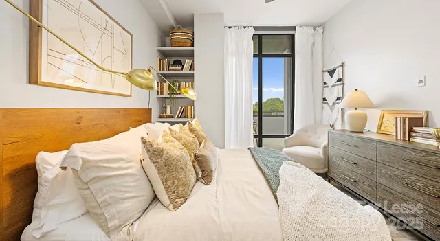 a bedroom with a bed and glass door