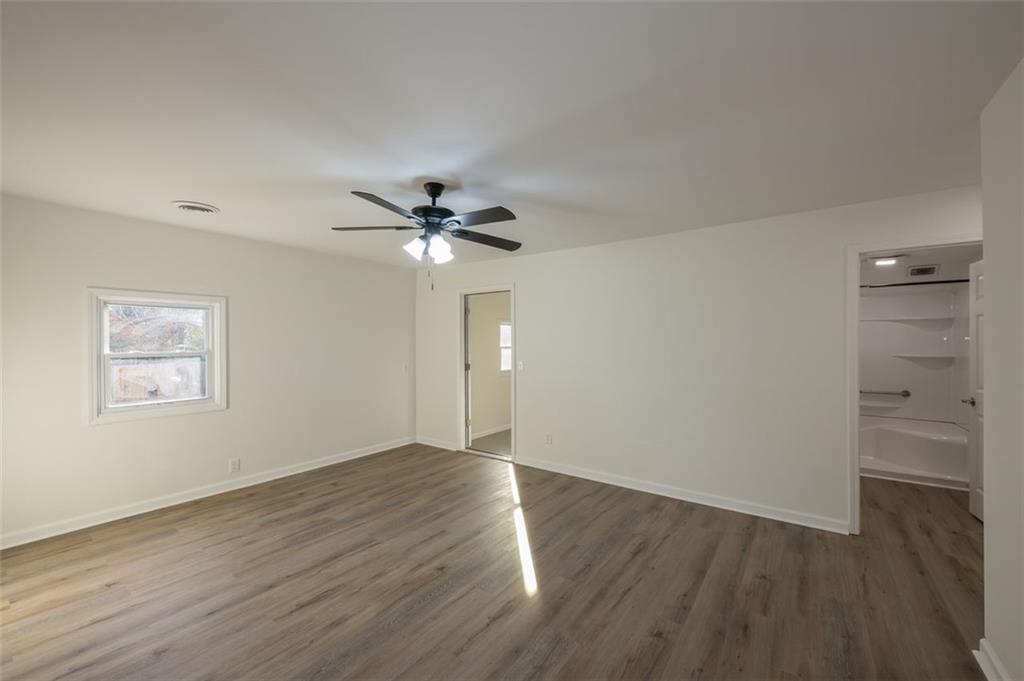 5081 Hubert Drive Powder Springs, GA 30127 - Photo 17 of 32 an empty room with wooden floor closet and fan