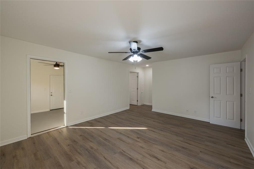 5081 Hubert Drive Powder Springs, GA 30127 - Photo 18 of 32 a view of an empty room with wooden floor