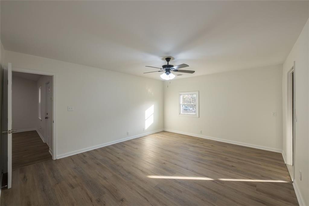 5081 Hubert Drive Powder Springs, GA 30127 - Photo 20 of 32 a view of an empty room with wooden floor