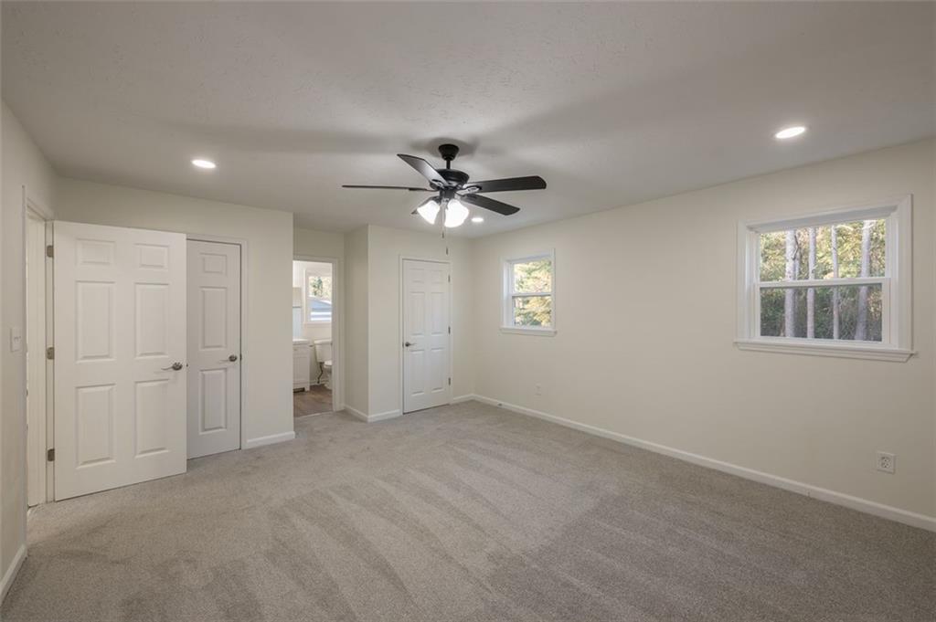 5081 Hubert Drive Powder Springs, GA 30127 - Photo 24 of 32 an empty room with windows and ceiling fan