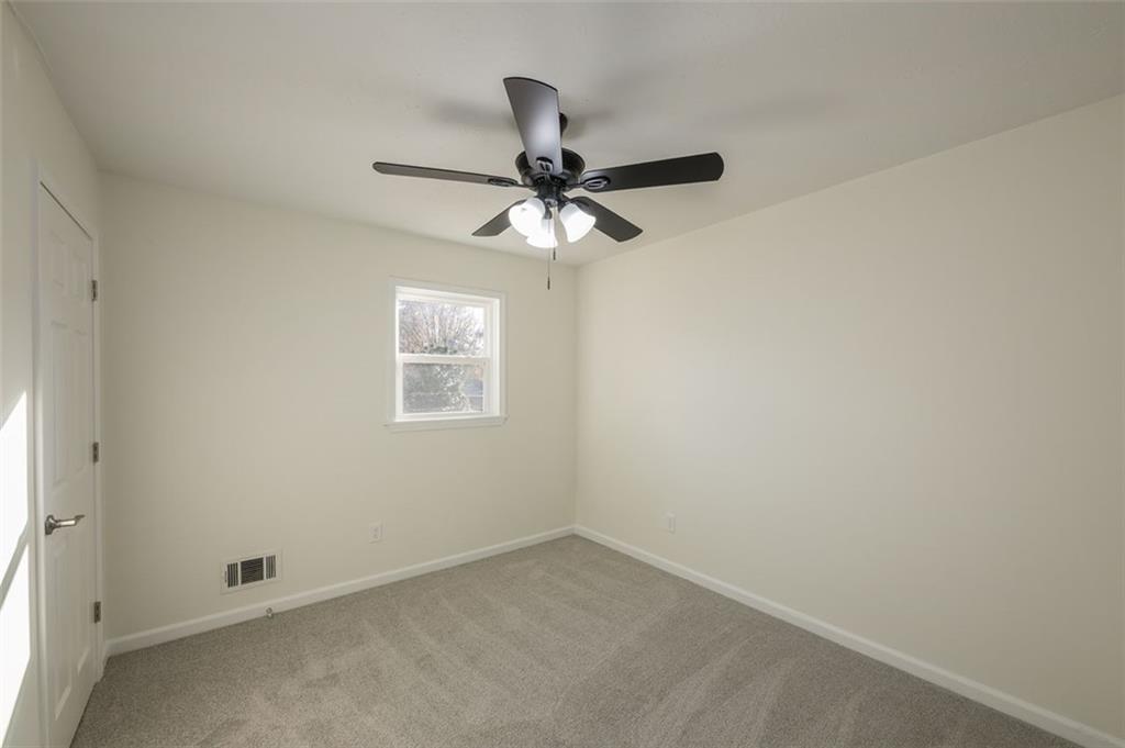 5081 Hubert Drive Powder Springs, GA 30127 - Photo 28 of 32 an empty room with a window and a fan