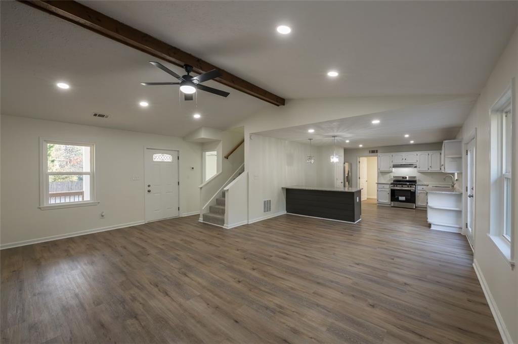 5081 Hubert Drive Powder Springs, GA 30127 - Photo 6 of 32 a view of a big room with wooden floor and windows