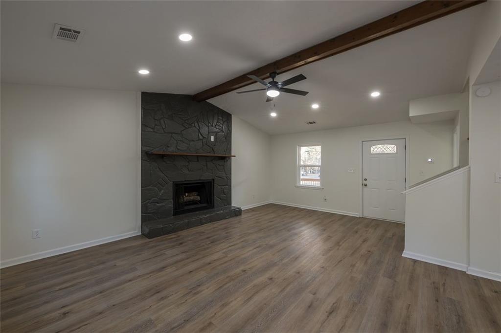 5081 Hubert Drive Powder Springs, GA 30127 - Photo 7 of 32 a view of an empty room with wooden floor fireplace and a window