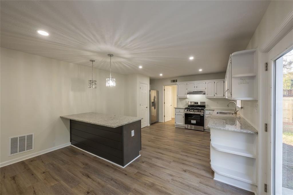 5081 Hubert Drive Powder Springs, GA 30127 - Photo 9 of 32 a view of kitchen with furniture and wooden floor