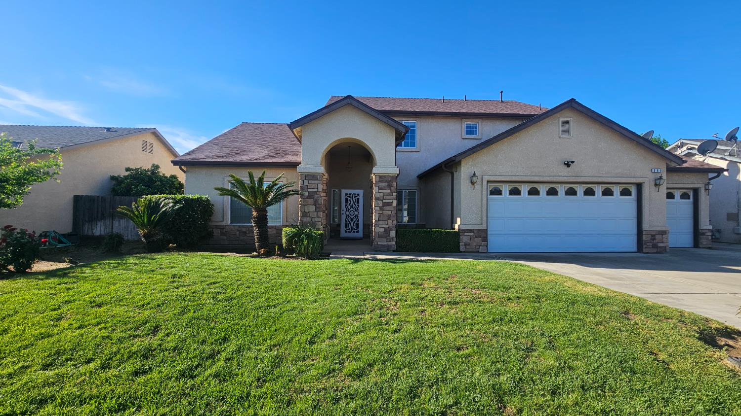 580 West Sunset Street Kingsburg, CA 93631 - Photo 1 of 12 a view of a house with a yard and garage