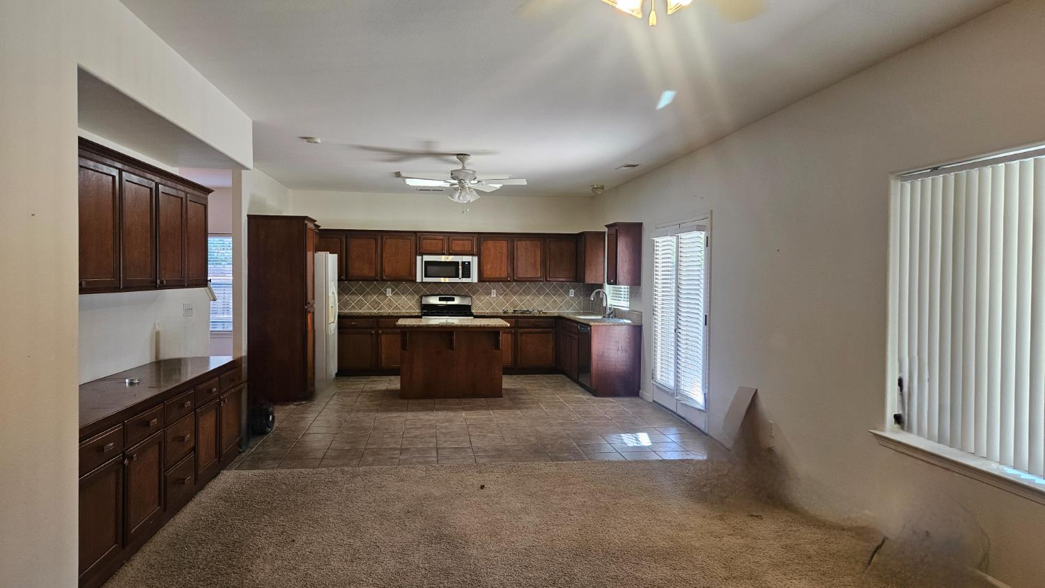 580 West Sunset Street Kingsburg, CA 93631 - Photo 5 of 12 a large kitchen with cabinets and stainless steel appliances