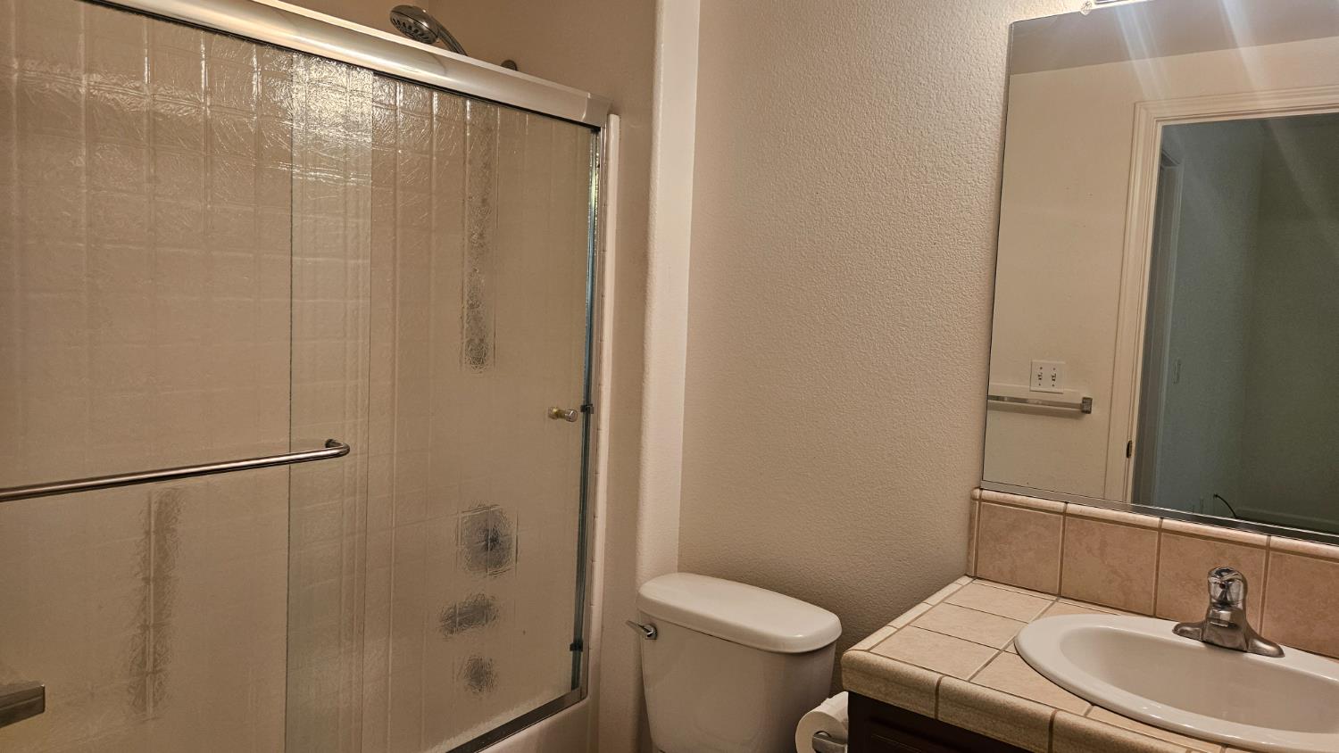 580 West Sunset Street Kingsburg, CA 93631 - Photo 10 of 12 a bathroom with a sink toilet and shower