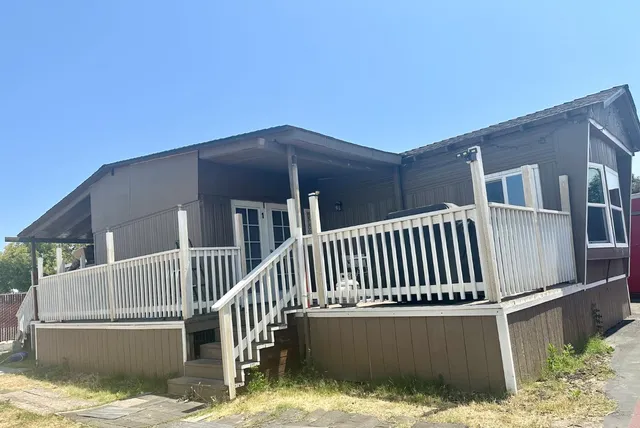 a view of a house with wooden fence