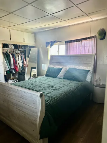 a bedroom with a bed and a mirror