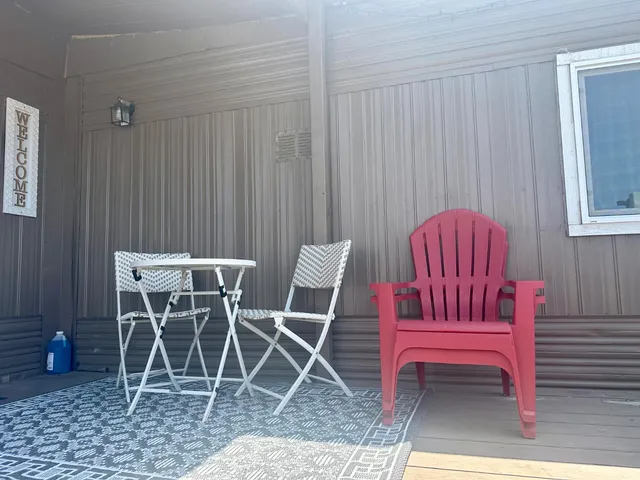 a view of a room with furniture and a rug