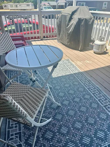 a wooden bench sitting in front of a building
