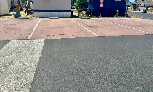 a view of backyard with parking area