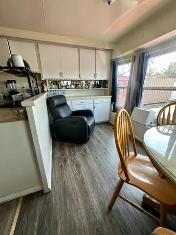 a kitchen with a table chairs and a wooden floor