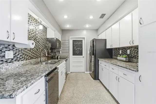 a kitchen with stainless steel appliances granite countertop a stove and cabinets