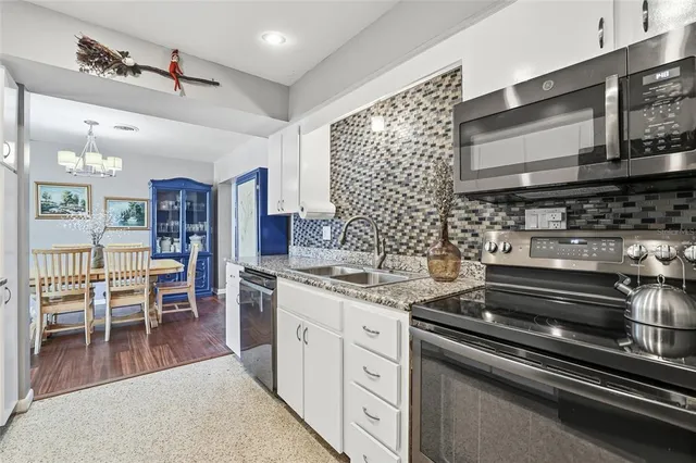 a spacious bedroom with a bed and wooden floor